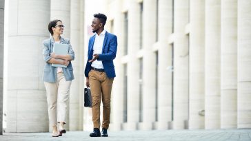 Two people walking and talking