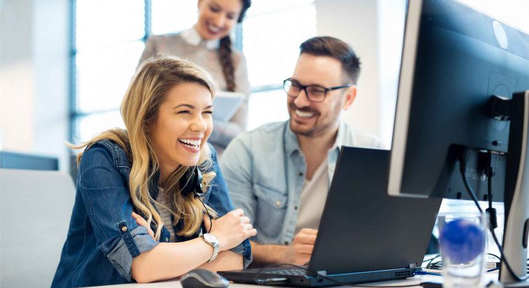 man and woman working together on a laptop